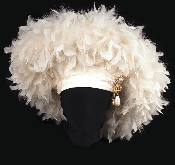 Шляпка белая рукотворная в виде крупного берета, украшенная страусовыми светлыми перьями с подвесами под золото, украшенными стразами.